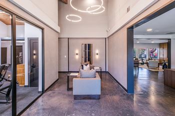 A modern living room with a marble floor and a large white sofa.